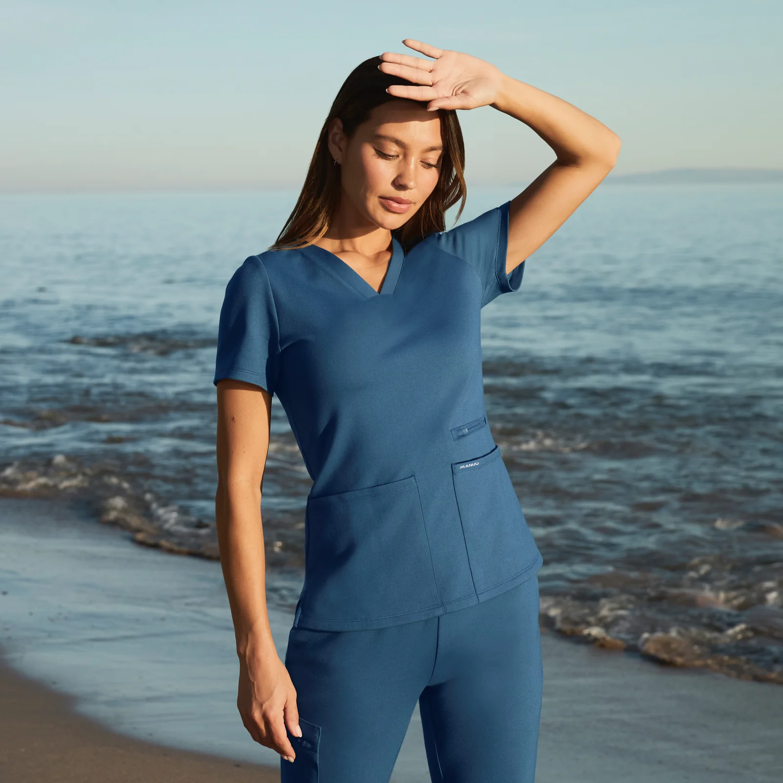 Model wearing ROUNDS performance scrubs